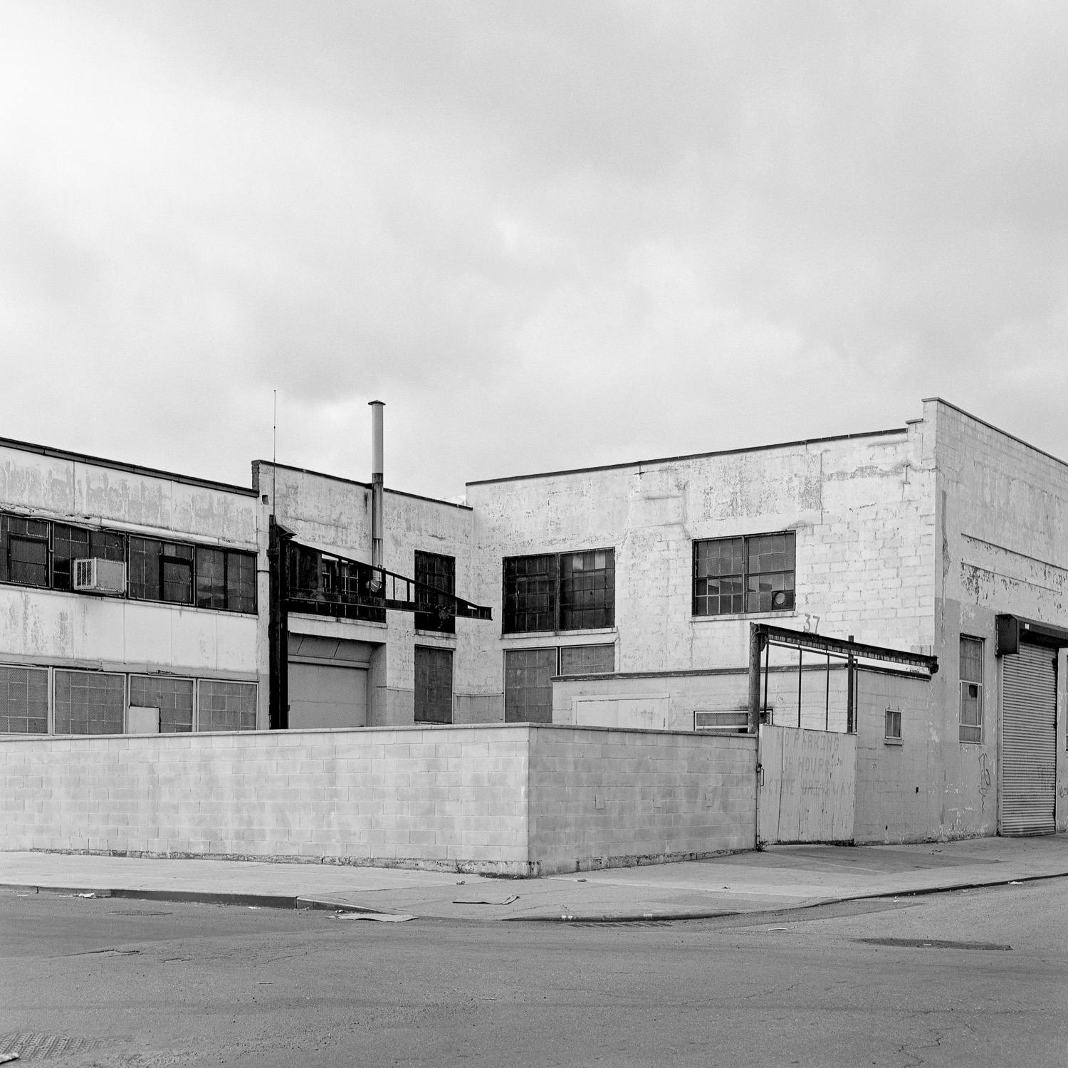 B&W image of white factory building.